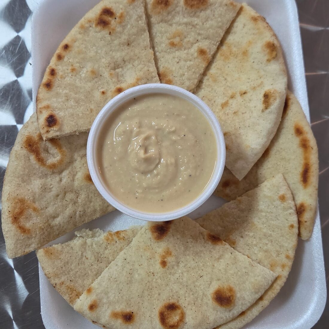 Hummus Special — Delicious blend of garbanzo beans, olive oil, and lemon juice served with fresh pita