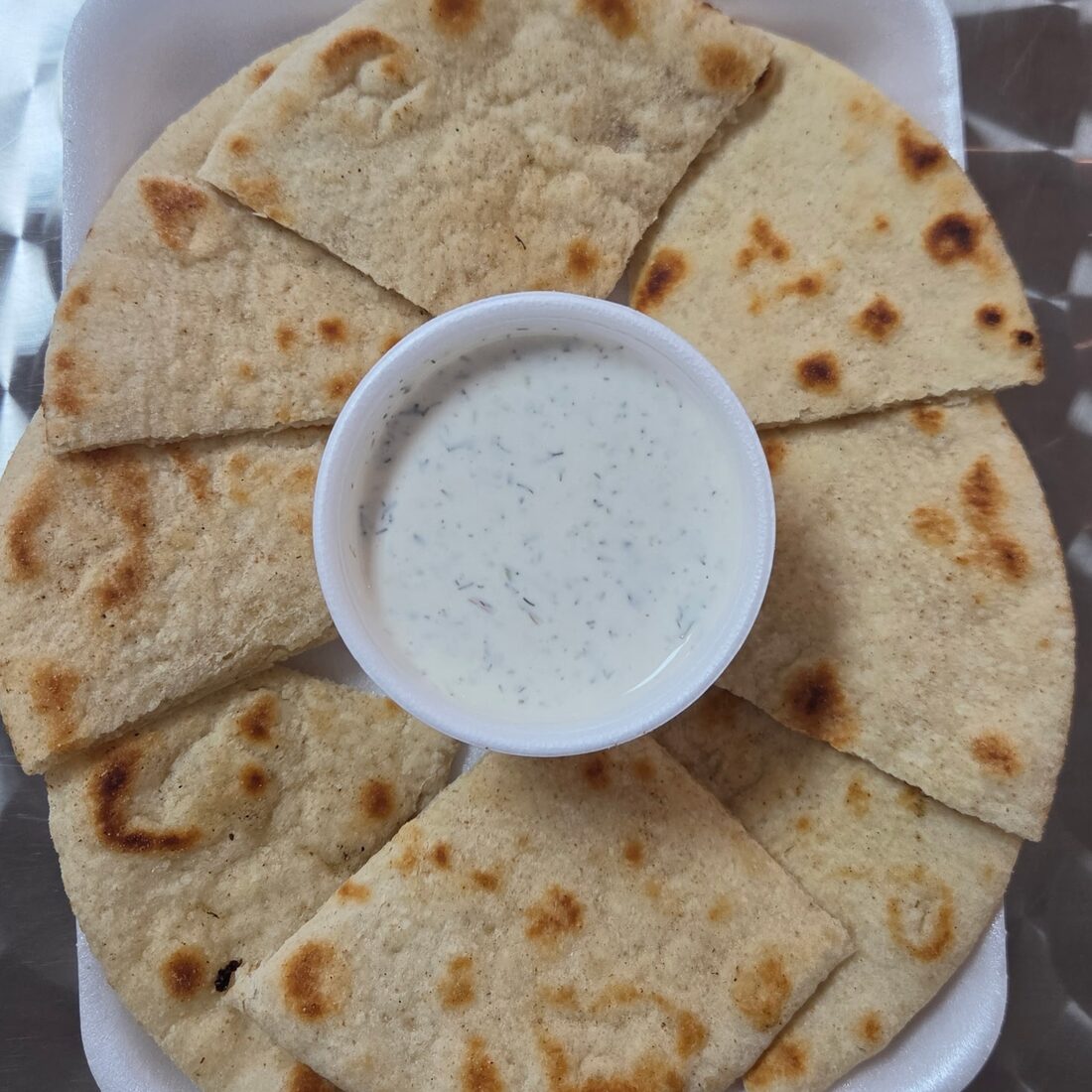 Lakis' Special — Wedges of freshly grilled pita served with house made tzatziki sauce